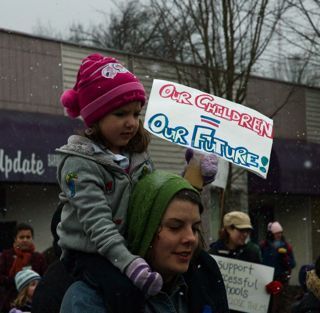 PHOTO CAPTION Woman and child march to Garfield Community Center. Photo By Acacia Jackson